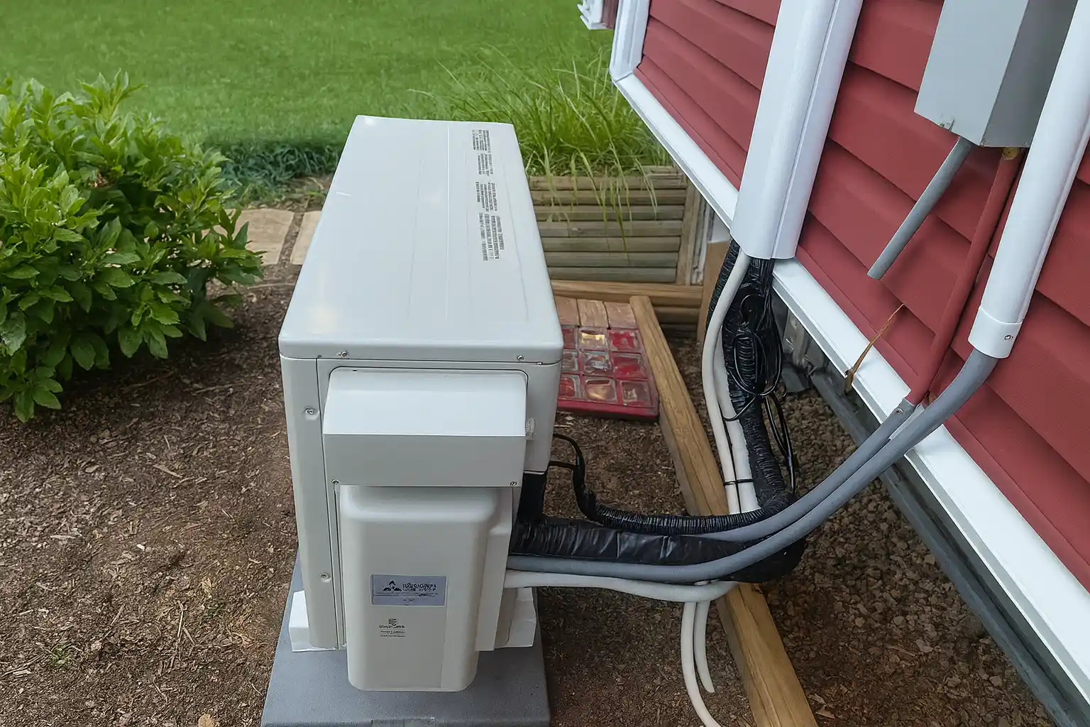 outdoor heat pump unit with insulated line sets installed by an hvac contractor at a home in baltimore md, showing professional exterior system setup