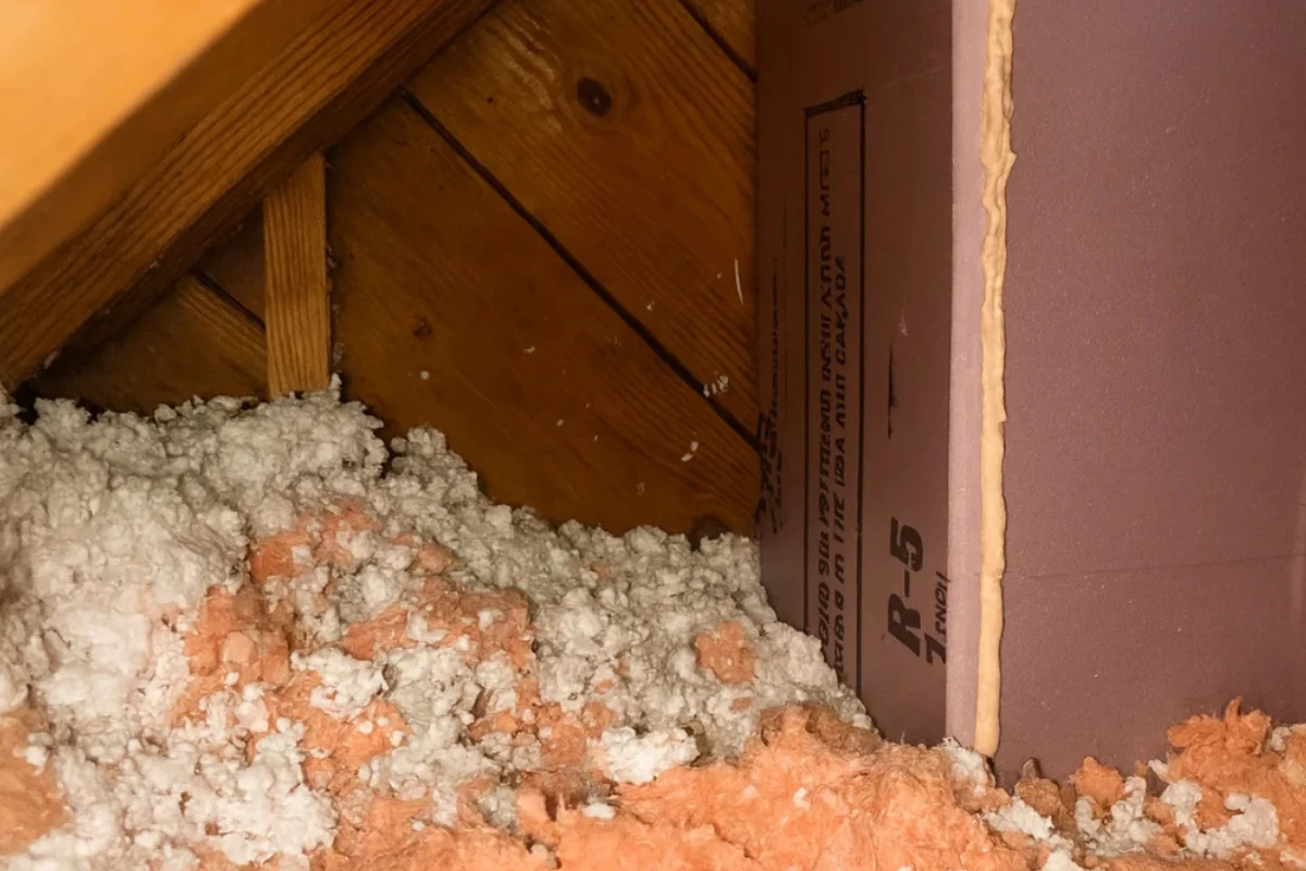 attic corner with blown-in insulation and R-5 foam board showing upgrade work by a White Marsh insulation contractor